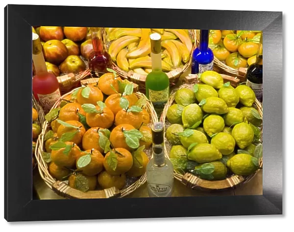 Window display of traditional marzipan fruits and grappa