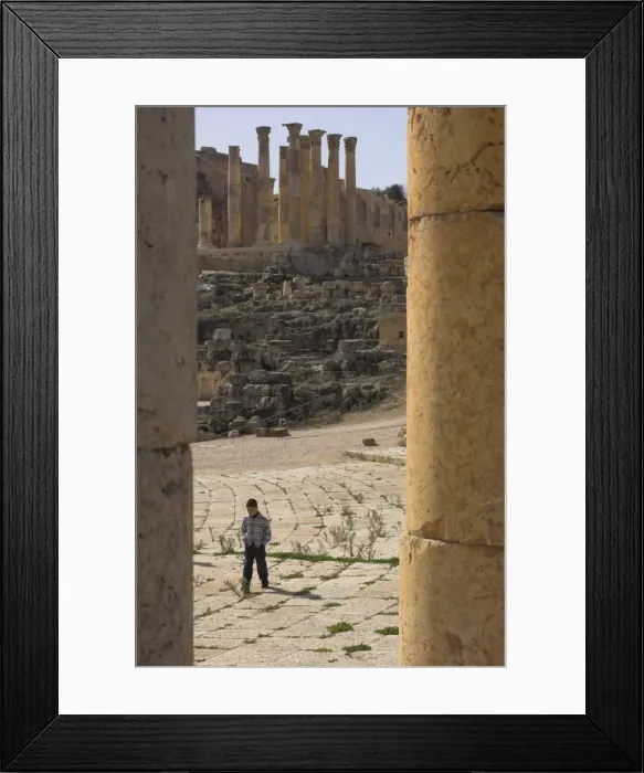 Framed Print : View through columns of boy walking past Framed Print : View through columns of boy walking past