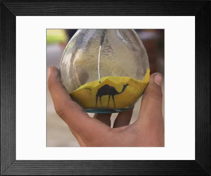 Framed Print : Close up of sand bottle with camel being drawn Framed Print : Close up of sand bottle with camel being drawn