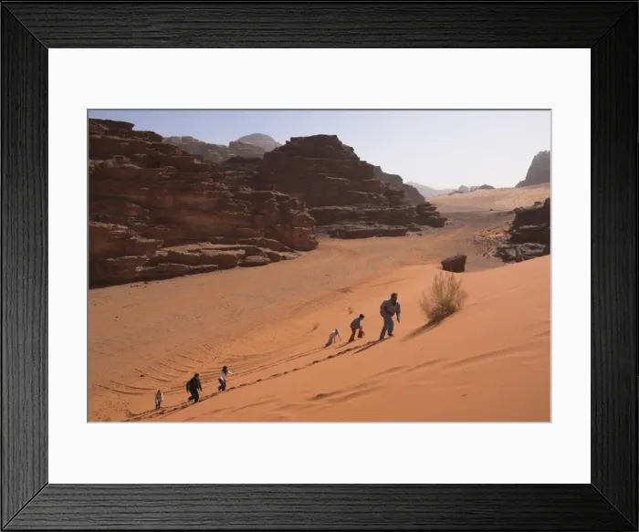 Framed Print : Young people climbing a typical red sand dune with Framed Print : Young people climbing a typical red sand dune with