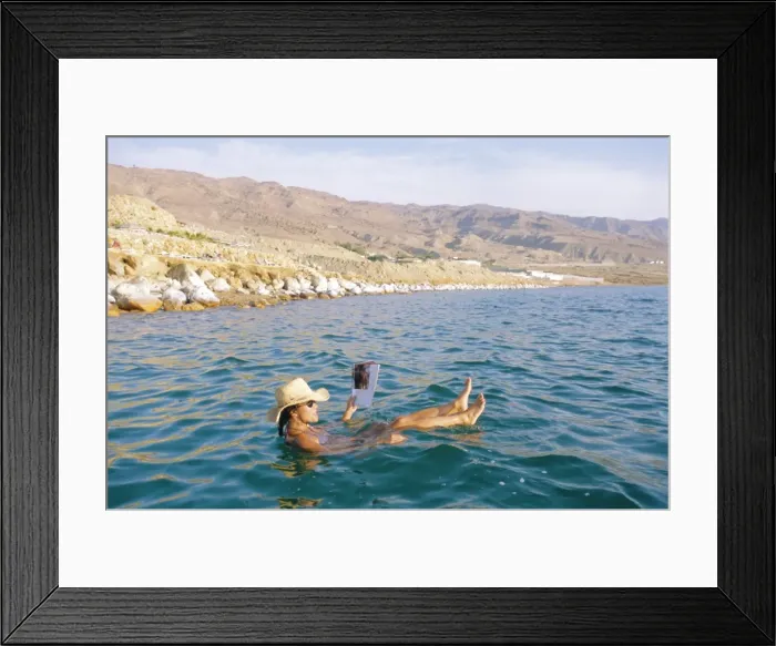 Framed Print : Woman floating in the Dead Sea reading a magazine Framed Print : Woman floating in the Dead Sea reading a magazine