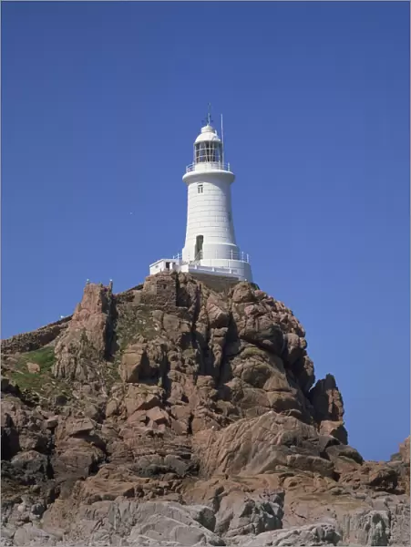 Lighthouse on rocks at Corbiere Point on the island of Jersey