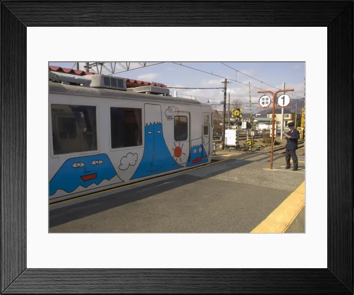 Framed Print : Local train at station platform with fun drawings of Mount Fuji Framed Print : Local train at station platform with fun drawings of Mount Fuji