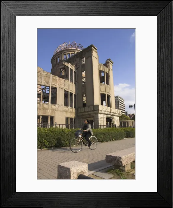 Framed Print : Woman riding bicycle past A Bomb Dome Framed Print : Woman riding bicycle past A Bomb Dome