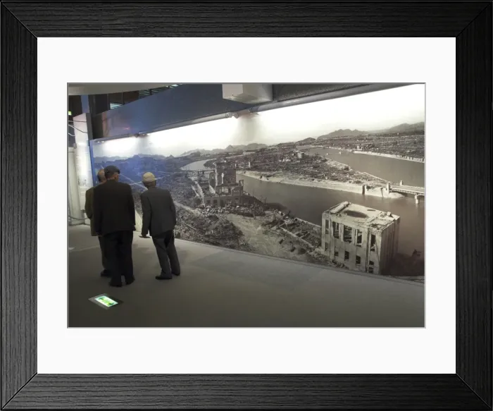 Framed Print : Visitors looking at huge wall poster showing the destruction Framed Print : Visitors looking at huge wall poster showing the destruction