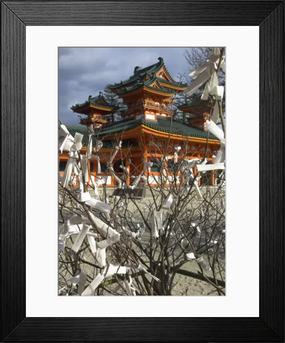 Framed Print : Fate and wish papers tied on a bush branches in foreground Framed Print : Fate and wish papers tied on a bush branches in foreground