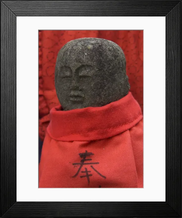 Framed Print : Small stone figure wearing traditional red dress Framed Print : Small stone figure wearing traditional red dress
