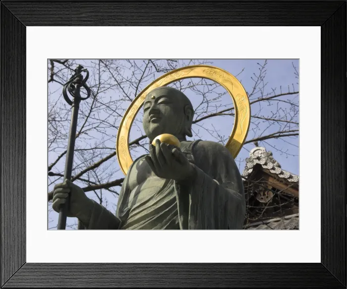 Framed Print : Bronze statue of the Buddha in front of a temple Framed Print : Bronze statue of the Buddha in front of a temple