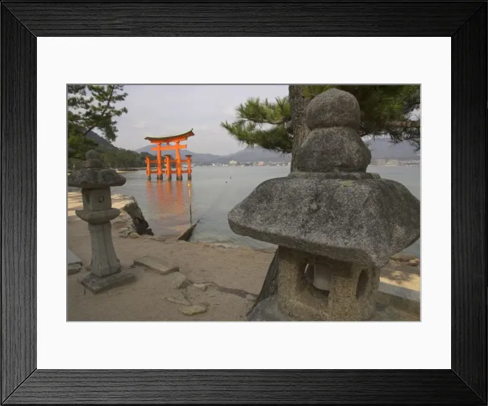 Framed Print : Traditional stone candle stands in foreground Framed Print : Traditional stone candle stands in foreground
