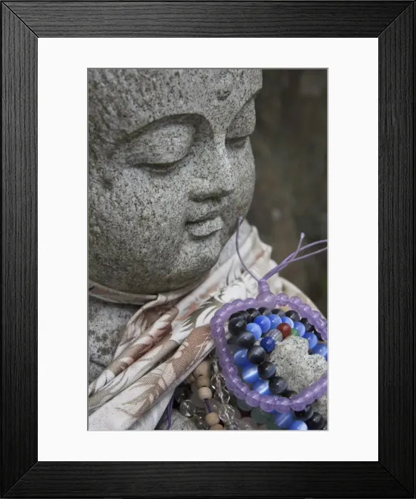 Framed Print : Close up of a traditional stone figure with prayer bracelets Framed Print : Close up of a traditional stone figure with prayer bracelets
