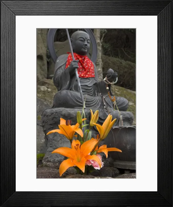 Framed Print : Traditional bronze figure of Buddha with red scarf and fresh flowers Framed Print : Traditional bronze figure of Buddha with red scarf and fresh flowers