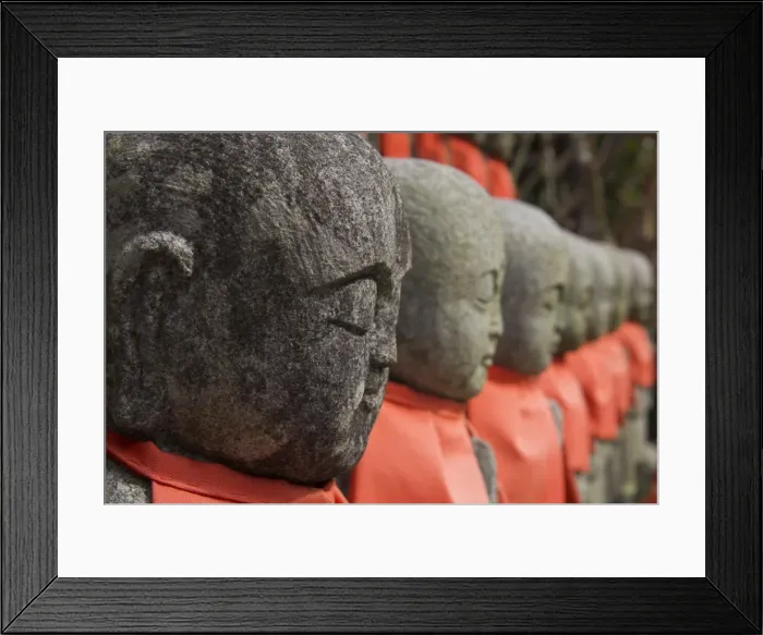 Framed Print : Close up of a row of stone figures wearing red cloth Framed Print : Close up of a row of stone figures wearing red cloth