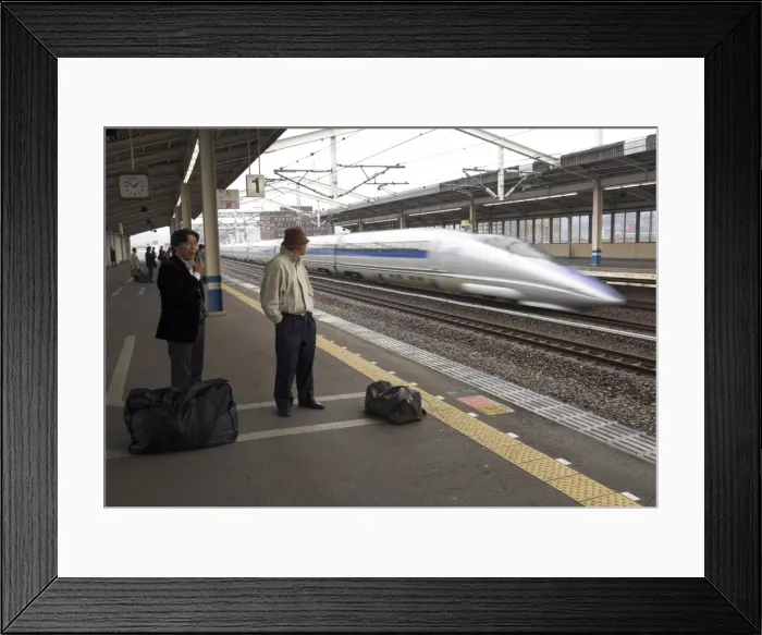 Framed Print : People waiting on platform with Nozomi train passing at great speed Framed Print : People waiting on platform with Nozomi train passing at great speed