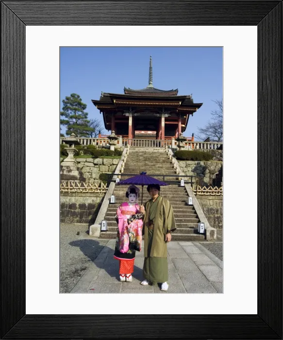 Framed Print : Couple holding parasol Framed Print : Couple holding parasol