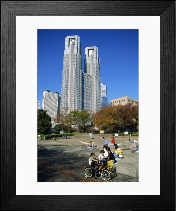 Framed Print : Children play in a park below the New Tokyo City Hall in Shinjuku Framed Print : Children play in a park below the New Tokyo City Hall in Shinjuku