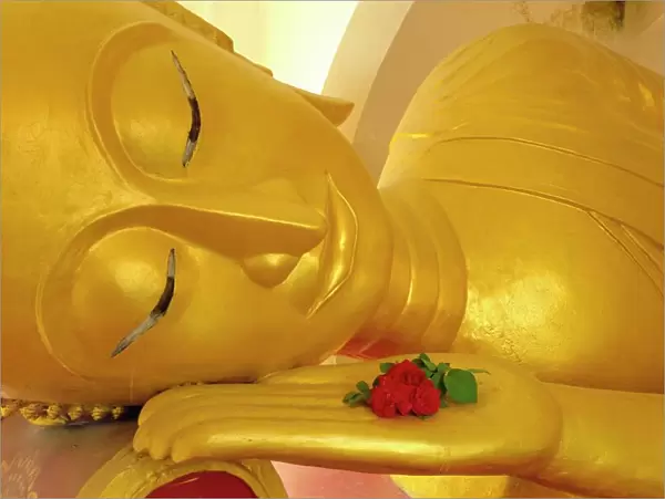 Close up of the head of a reclining Buddha statue
