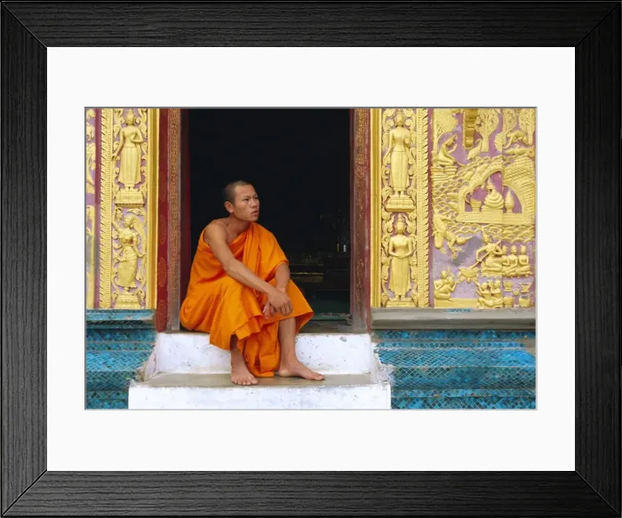 Framed Print : Monk in the doorway of Wat Xieng Thong