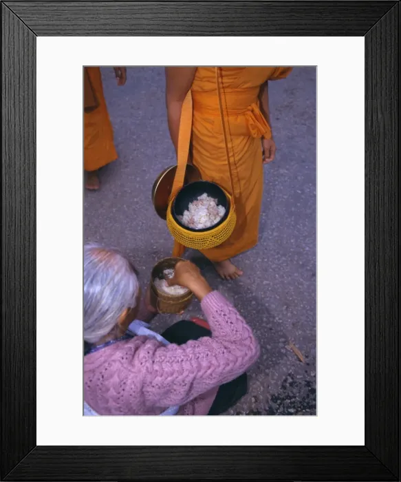Framed Print : Novice monk receiving alms in the early morning Framed Print : Novice monk receiving alms in the early morning