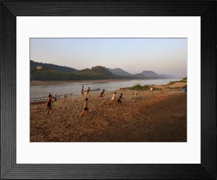 Framed Print : Playing football on the banks of the Mekong river Framed Print : Playing football on the banks of the Mekong river