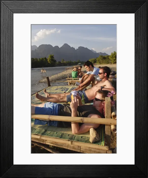 Framed Print : Backpackers relax by the Nam Song river in Vang Vieng Framed Print : Backpackers relax by the Nam Song river in Vang Vieng