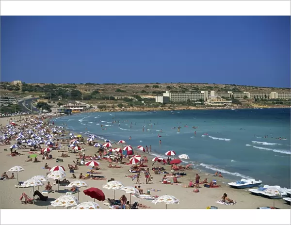 Tourists on the beach at Mellieha Bay on the island of Malta