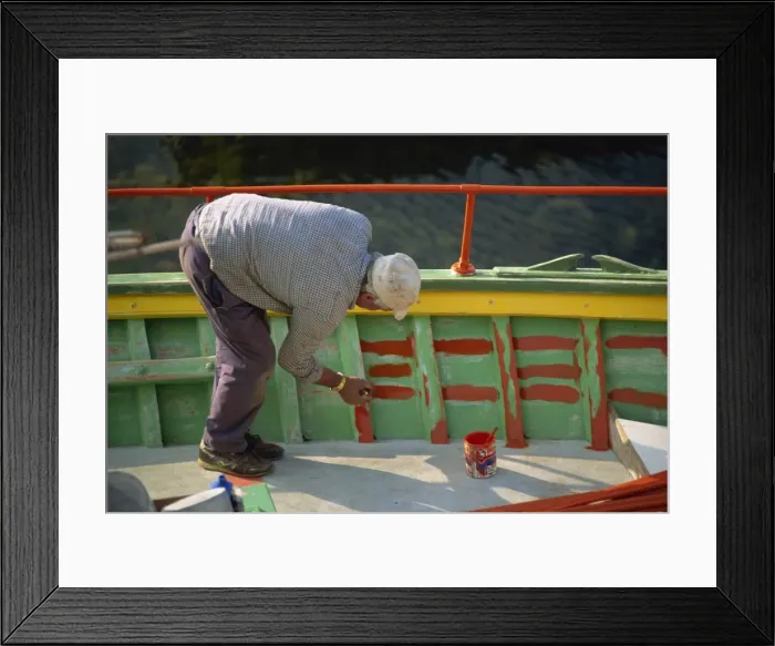 Framed Print : Man painting the inside of a boat on Malta Framed Print : Man painting the inside of a boat on Malta