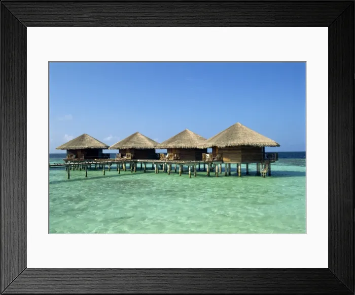 Framed Print : Thatched cabins above the ocean on the tropical island Framed Print : Thatched cabins above the ocean on the tropical island