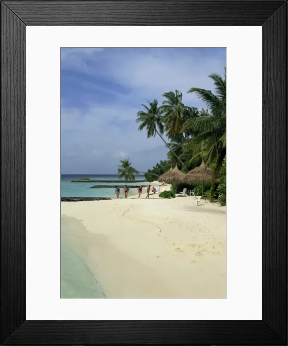 Framed Print : Women on the beach with thatched umbrellas and palm Framed Print : Women on the beach with thatched umbrellas and palm