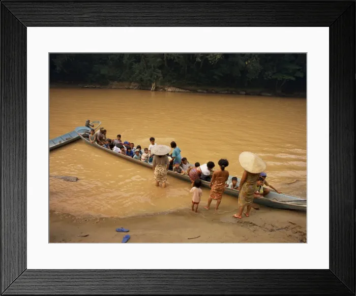 Framed Print : A longboat crowded with children leaving for week at school Framed Print : A longboat crowded with children leaving for week at school