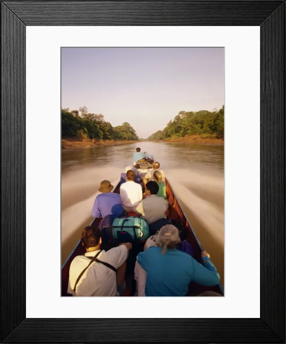 Framed Print : Tourists in longboat on a river in the Mulu National Park in Sarawak Framed Print : Tourists in longboat on a river in the Mulu National Park in Sarawak