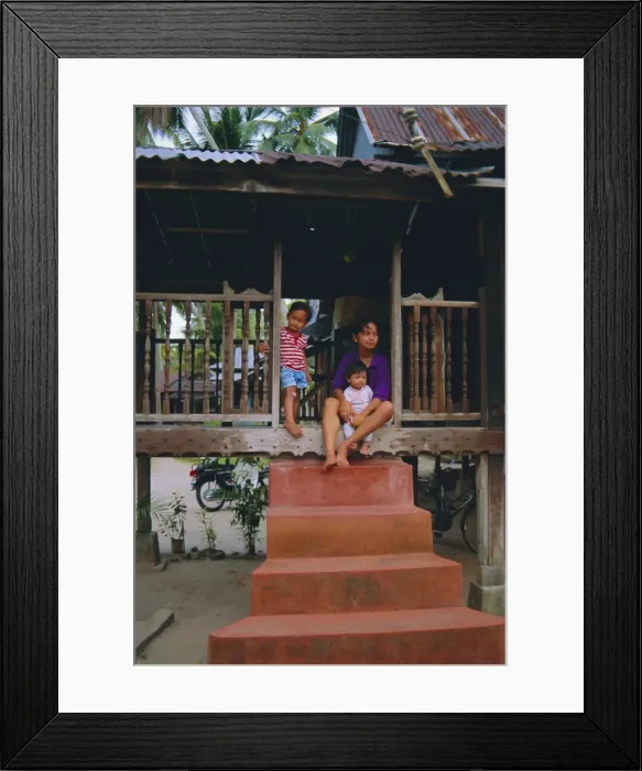 Framed Print : Stilt house and local family in traditional Malayan village Framed Print : Stilt house and local family in traditional Malayan village