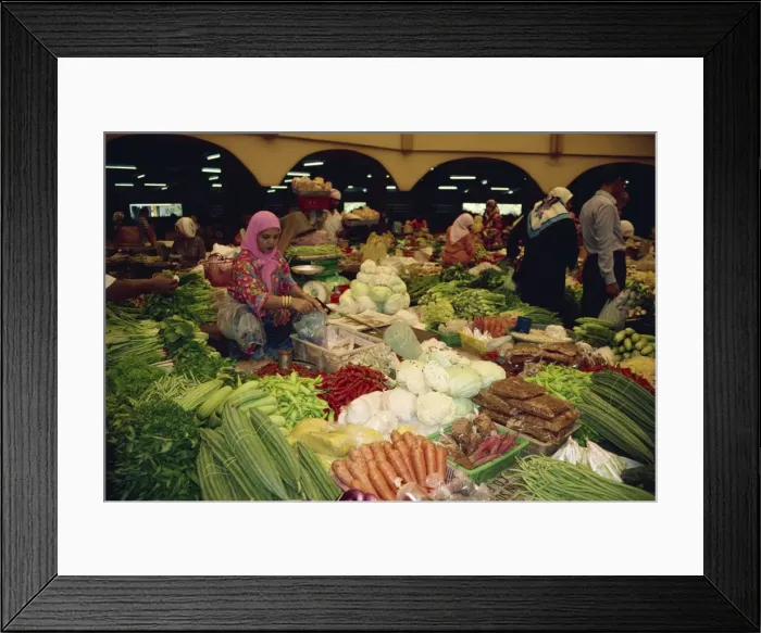 Framed Print : Woman selling vegetables from her stall in the central
