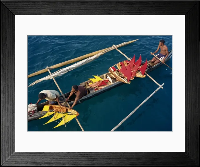 Framed Print : Local men transport model boats by canoe to market Framed Print : Local men transport model boats by canoe to market