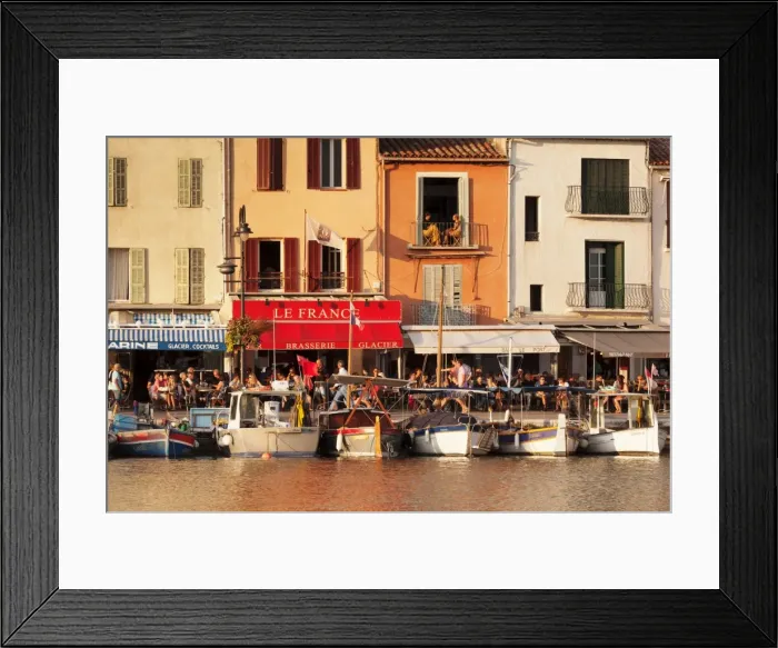 Framed Print : Fishing boats at the harbour, restaurants and street cafes on the promenade, Cassis Framed Print : Fishing boats at the harbour, restaurants and street cafes on the promenade, Cassis