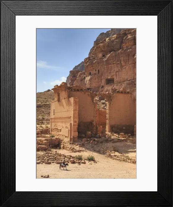 Framed Print : Local man on donkey passes Qasr al-Bint temple, elevated view, City of Petra ruins
