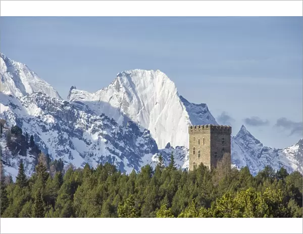 The Belvedere Tower frames the snowy peaks and Peak Badile on a spring day, Maloja Pass