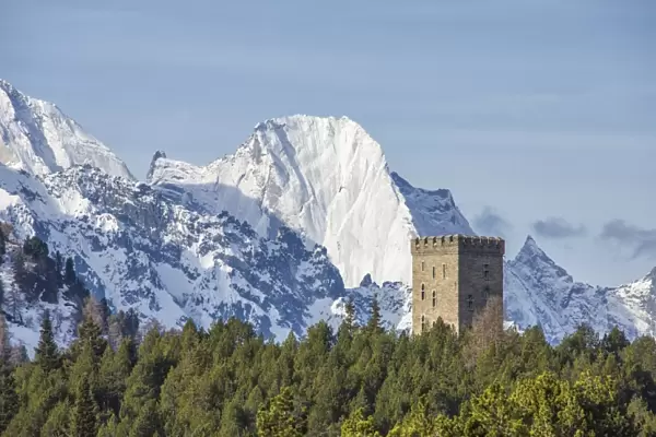 The Belvedere Tower frames the snowy peaks and Peak Badile on a spring day, Maloja Pass