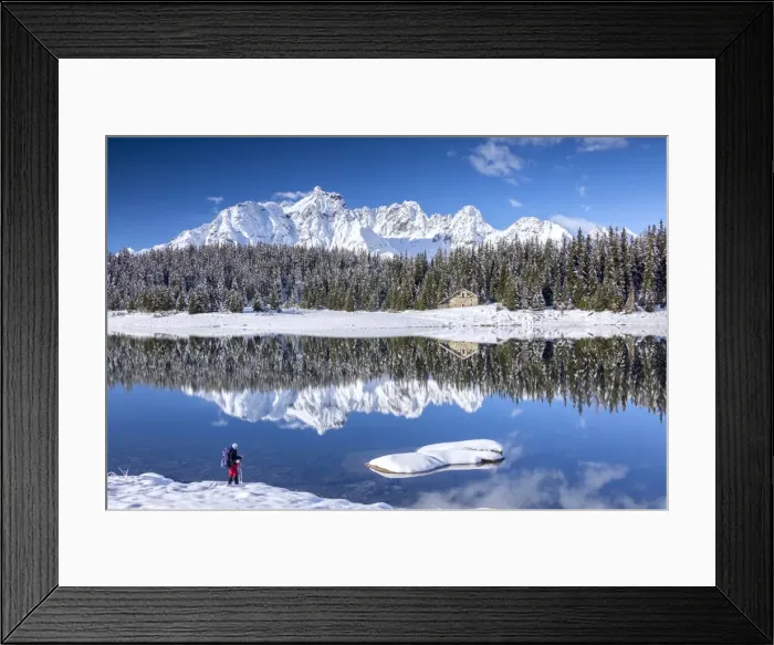 Framed Print : Hiker admires the snowy peaks and woods reflected in Lake Palu, Malenco Valley, Valtellina Framed Print : Hiker admires the snowy peaks and woods reflected in Lake Palu, Malenco Valley, Valtellina