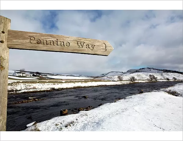 Sign for the Pennine Way walking trail on snowy landscape by the River Tees, Upper Teesdale
