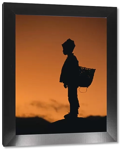 Silhouette of local boy at sunset