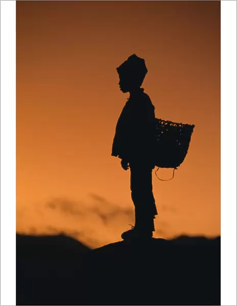Silhouette of local boy at sunset