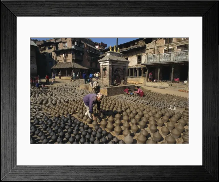 Framed Print : Man with rows of clay pots drying in Potters Square Framed Print : Man with rows of clay pots drying in Potters Square