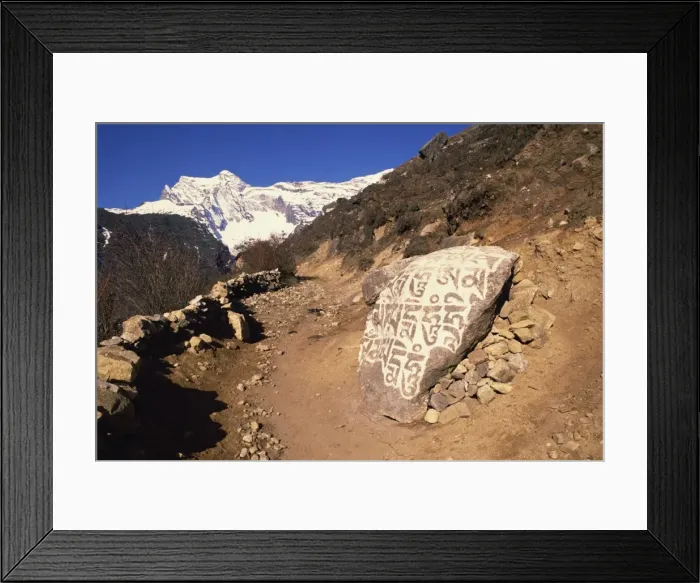 Framed Print : Mani stones printed with Tibetan prayers beside a track Framed Print : Mani stones printed with Tibetan prayers beside a track