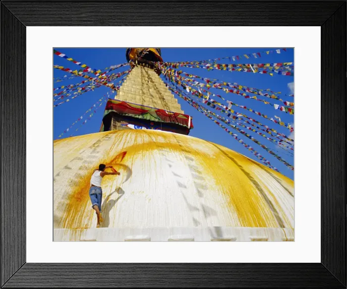 Framed Print : Young man throwing saffron water on the stupa in order Framed Print : Young man throwing saffron water on the stupa in order