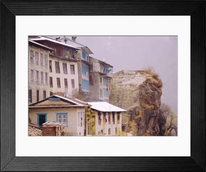 Framed Print : Houses and painted Sutras (Mahayana Buddhist scriptures) on a rock Framed Print : Houses and painted Sutras (Mahayana Buddhist scriptures) on a rock
