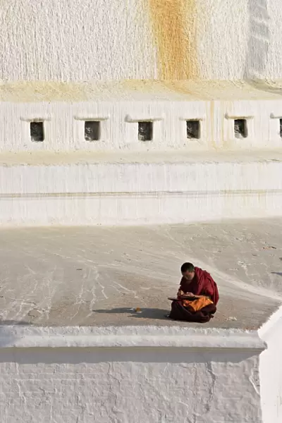 Tibetan Buddhist monk reading scriptures at the Boudha