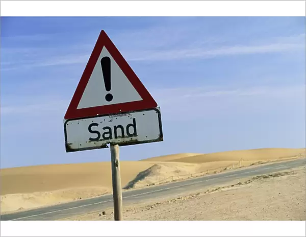 Road sign warning of sand