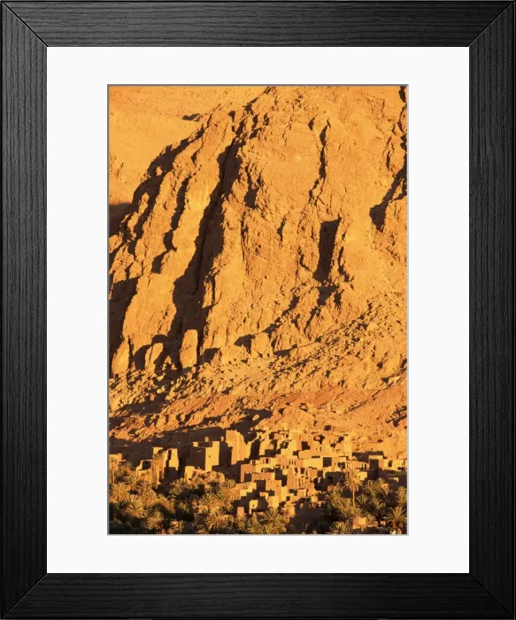 Framed Print : Remains of the kasbah at foot of towering cliffs at sunrise Framed Print : Remains of the kasbah at foot of towering cliffs at sunrise