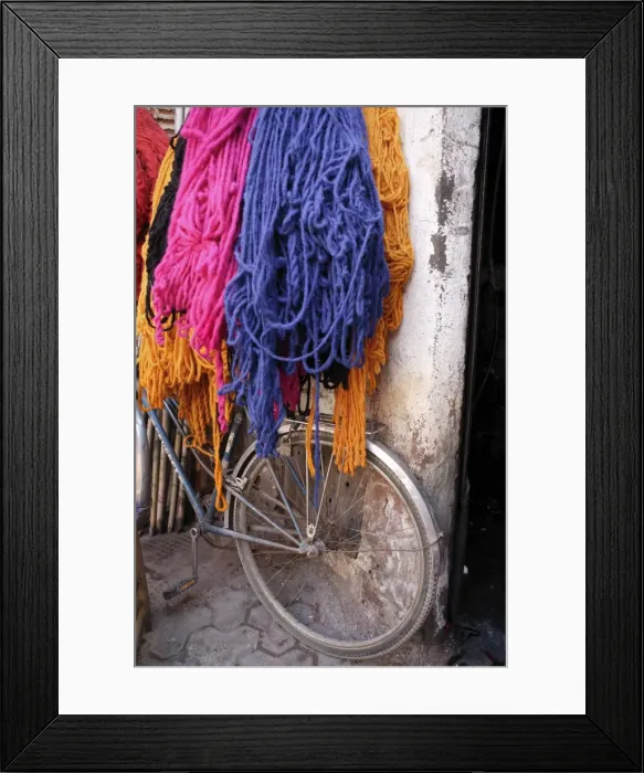 Framed Print : Brightly dyed wool hanging over bicycle Framed Print : Brightly dyed wool hanging over bicycle