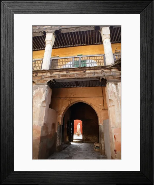 Framed Print : View out from courtyard with figure walking by Framed Print : View out from courtyard with figure walking by
